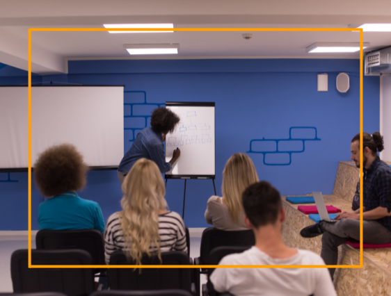 person writing on flip chart