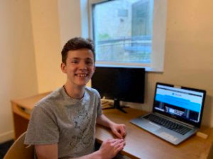 john painter sits at a desk