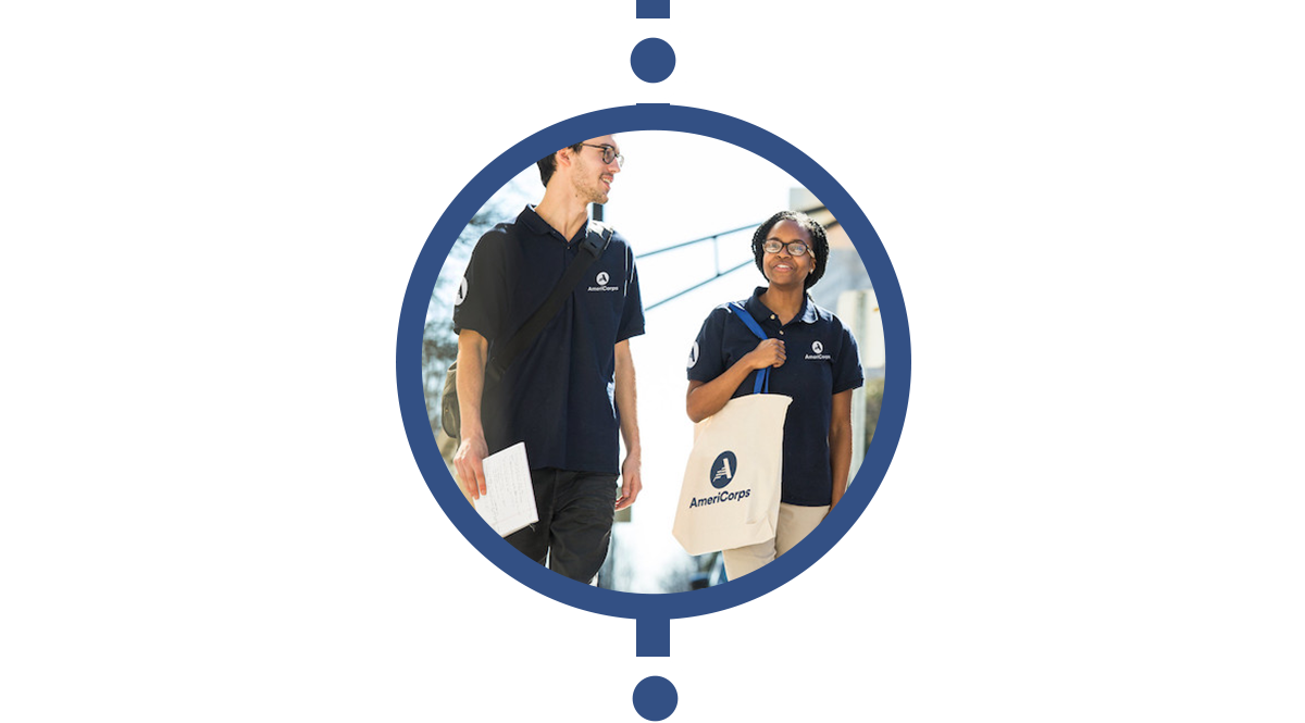 two americorps members talk while walking