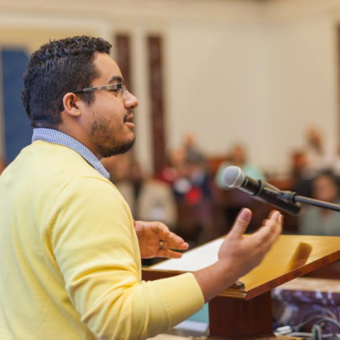newman fellow speaking into a microphone