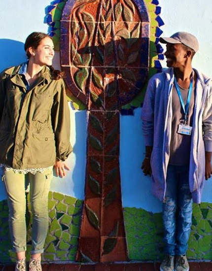 students standing in front of mural
